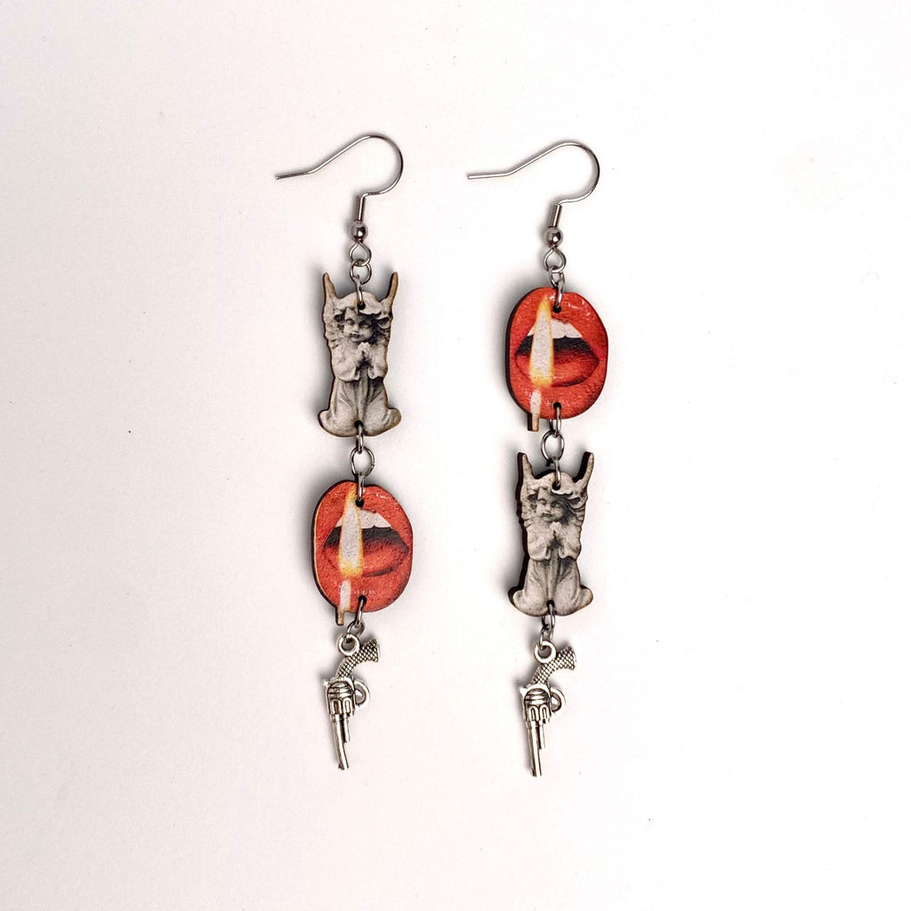 Pair of earrings, lips with flame, a statue of a cherub, a mini gun